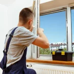 worker-installing-checking-window-house-2
