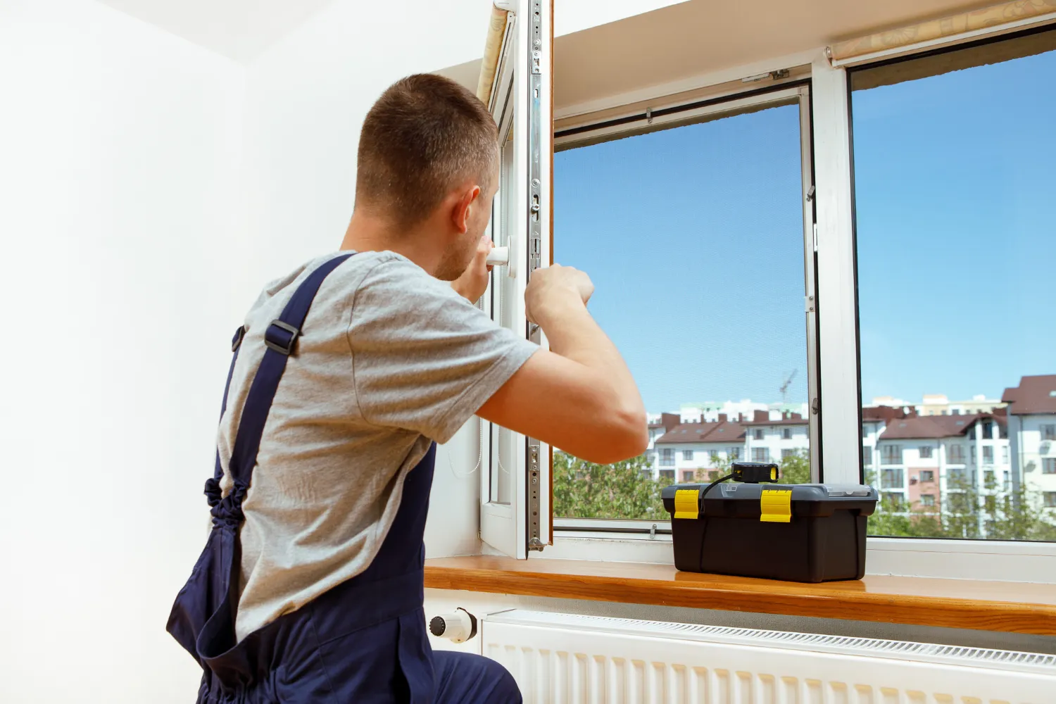 worker-installing-checking-window-house-2
